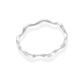 Top-down view of a polished silver bangle with an organic, wavy shape. The bangle is casting a soft shadow on a white background.