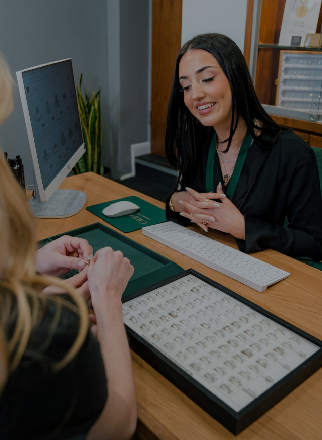 A consultation area within Griffin & Co Fine Jewellery, where a customer is viewing rings with assistance from a staff member.