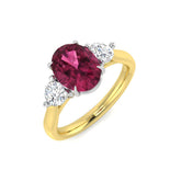 A three-stone engagement ring with an oval pink tourmaline and round diamonds, featuring a 9ct yellow gold band and platinum settings.