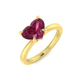 A 9ct yellow gold solitaire ring featuring a large, 3.79ct heart-cut synthetic pink gemstone in a five-prong setting.