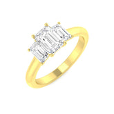 An angled view of a 9ct yellow gold trilogy engagement ring, featuring three graduated emerald cut lab grown diamonds held in white gold claw settings.