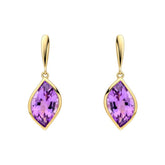 Gold earrings with purple gemstones on a white background
