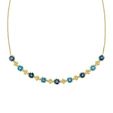 A close-up view of the blue topaz necklace, showing the detailed gold settings and the alternating shades of blue gemstones.