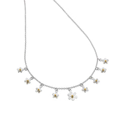 A silver charm necklace featuring multiple small daisies with yellow gold centres, suspended on a fine silver chain.