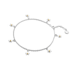 A sterling silver charm anklet featuring multiple small daisies with gold-plated centres, on a white background.