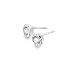 A pair of chunky, textured sterling silver stud earrings set with faceted white topaz stones, shown on a white background.