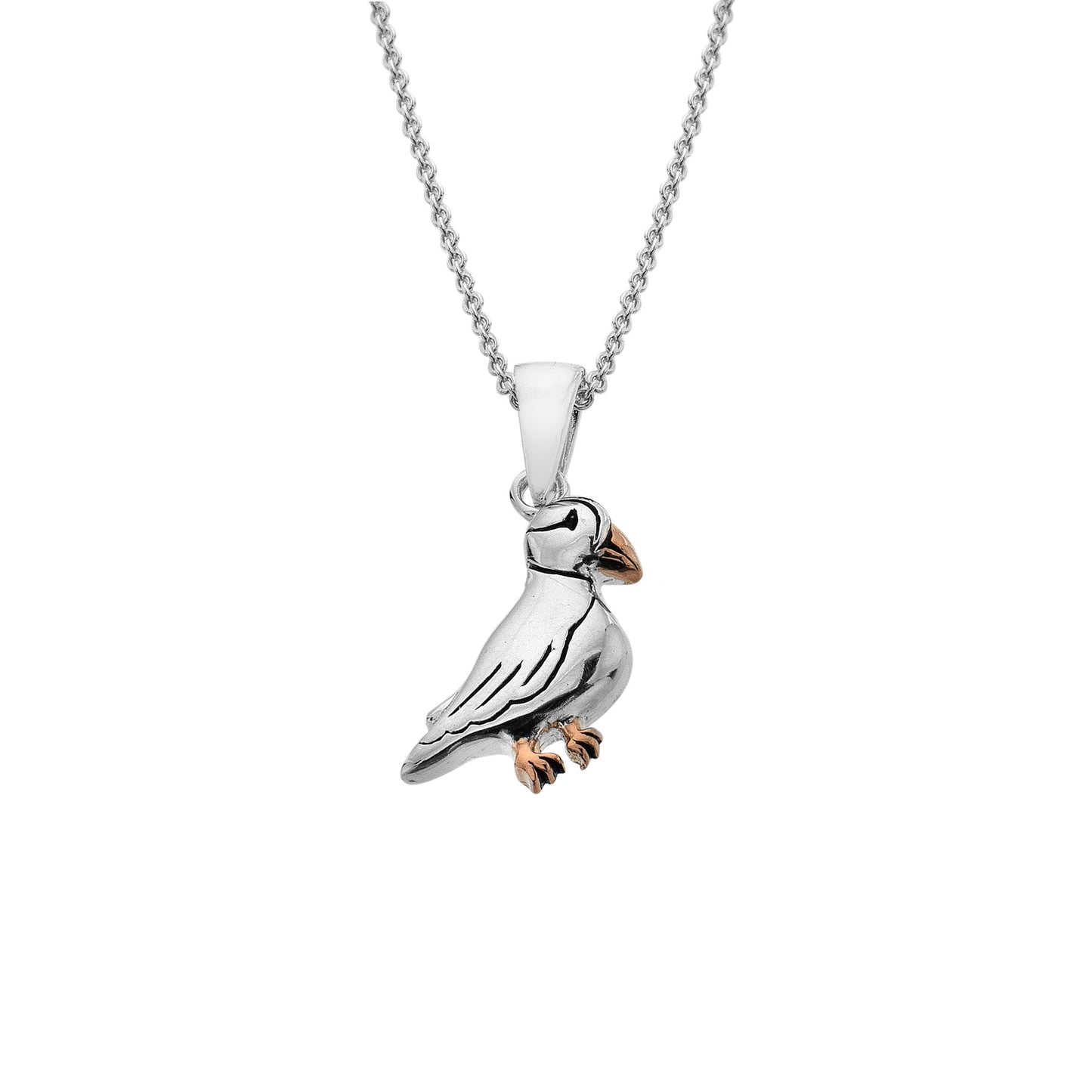 Studio shot of a handcrafted Sterling Silver puffin pendant with 18ct Rose Gold plated feet and beak.