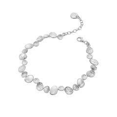 A sterling silver link bracelet featuring alternating polished and textured pebble shapes, with an extender chain, on a white background.