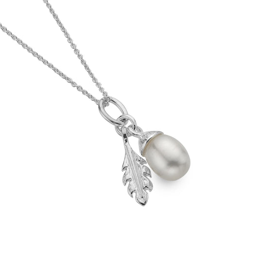 A sterling silver pendant necklace featuring a freshwater pearl acorn and a textured silver oak leaf charm, suspended on a fine chain on a white background. 1800