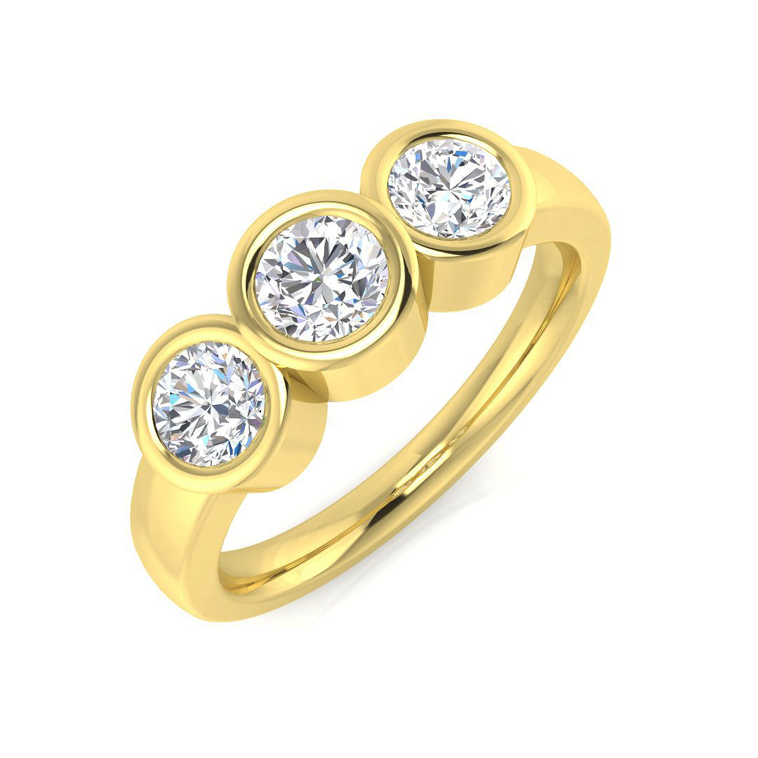 An angled view of a 9ct yellow gold trilogy engagement ring, featuring three round brilliant cut lab grown diamonds in smooth white gold rubover settings.
