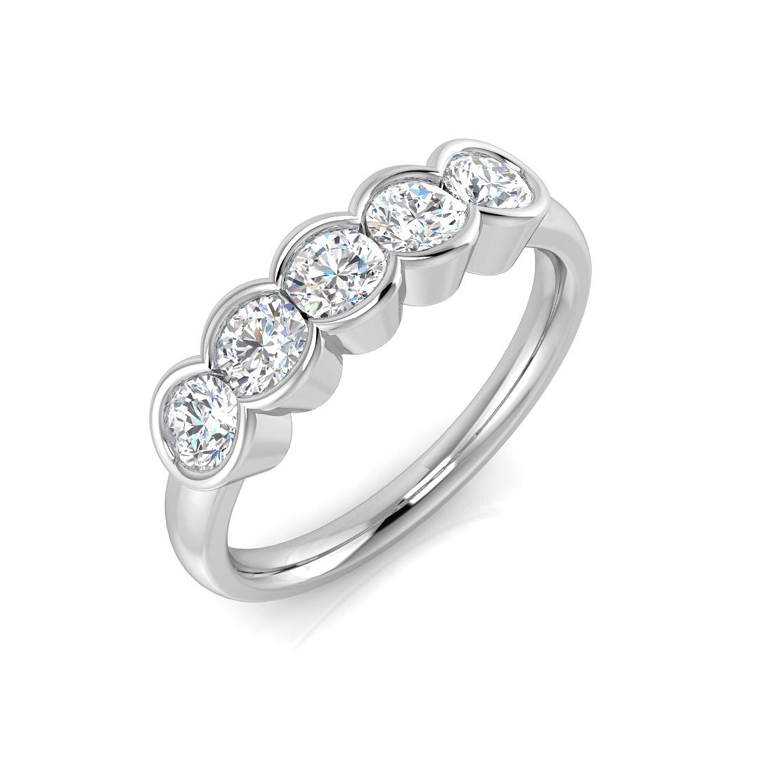 An angled view of a luxurious platinum five stone ring, featuring five round brilliant cut lab grown diamonds set in smooth rubover settings.