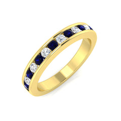 A 9ct yellow gold eternity ring featuring an alternating row of seven round blue sapphires and six brilliant-cut diamonds in a secure grain setting.