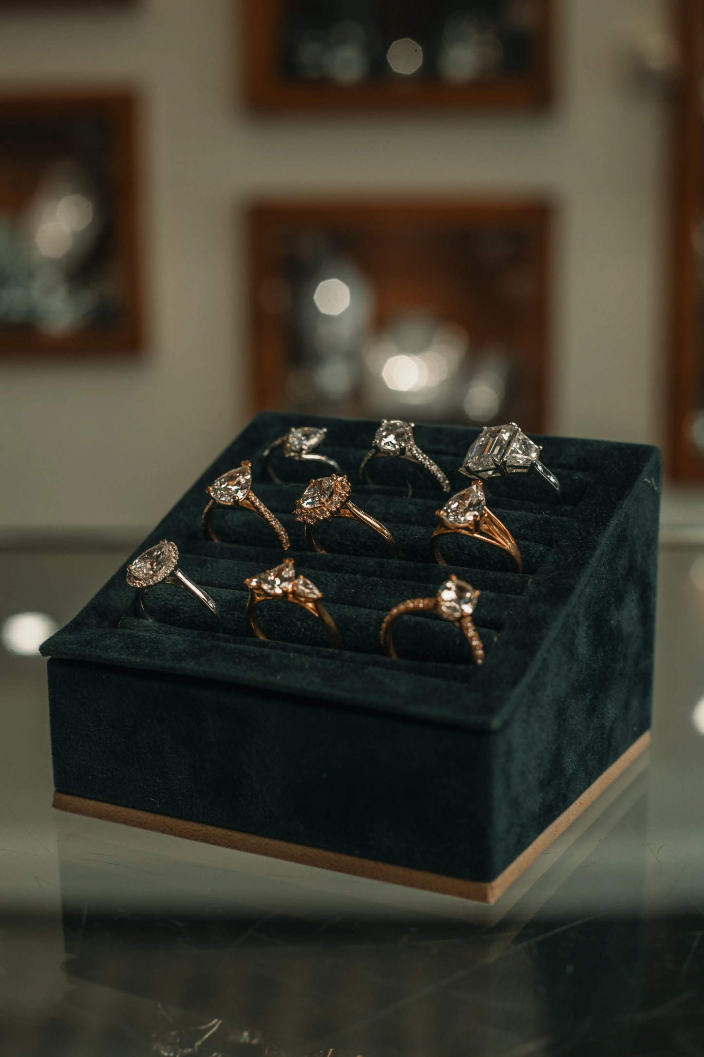 Set of diamond rings on a green velvet box with a blurred background