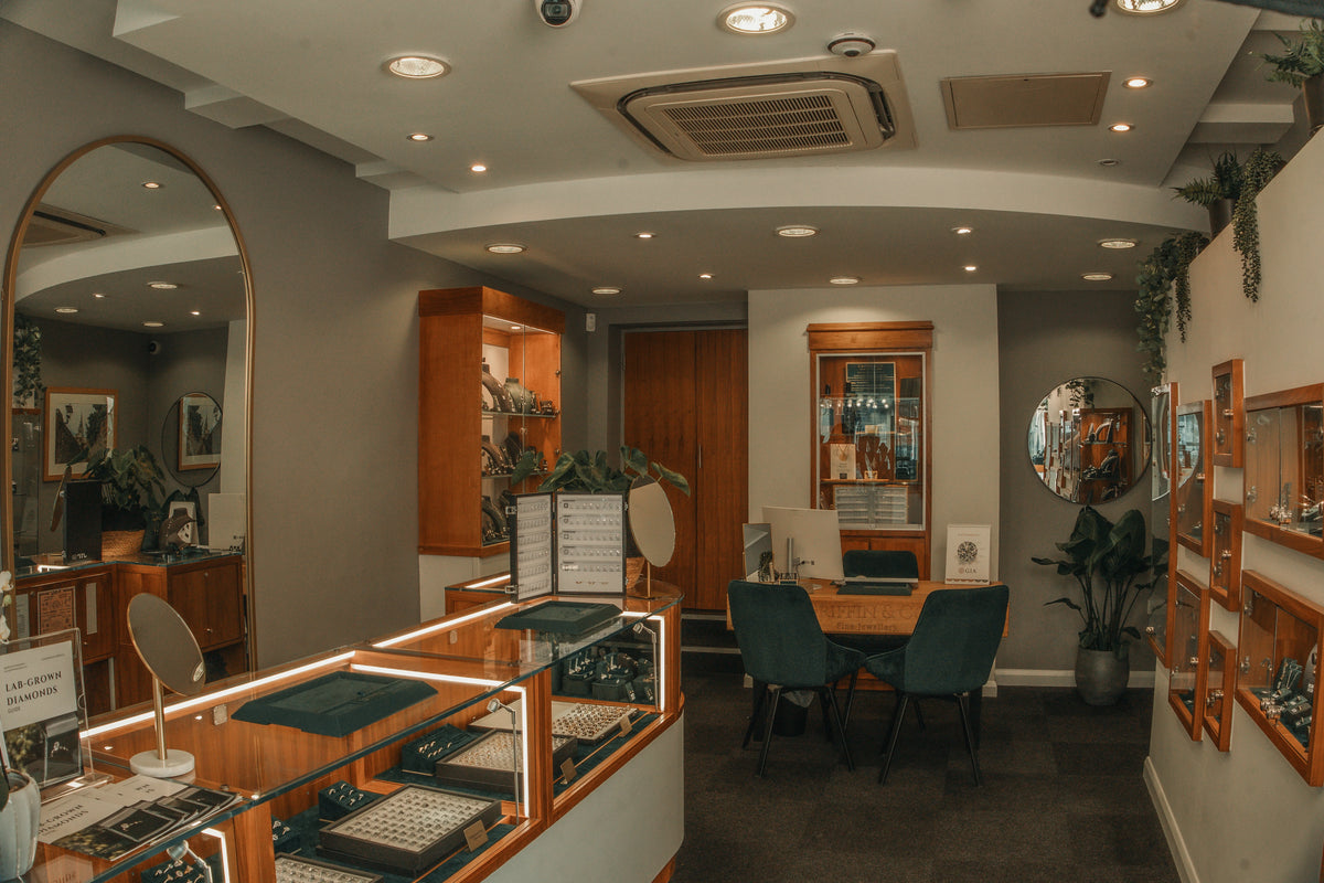 Interior of a Griffin & Co store with display cases, chairs, and a reception desk.