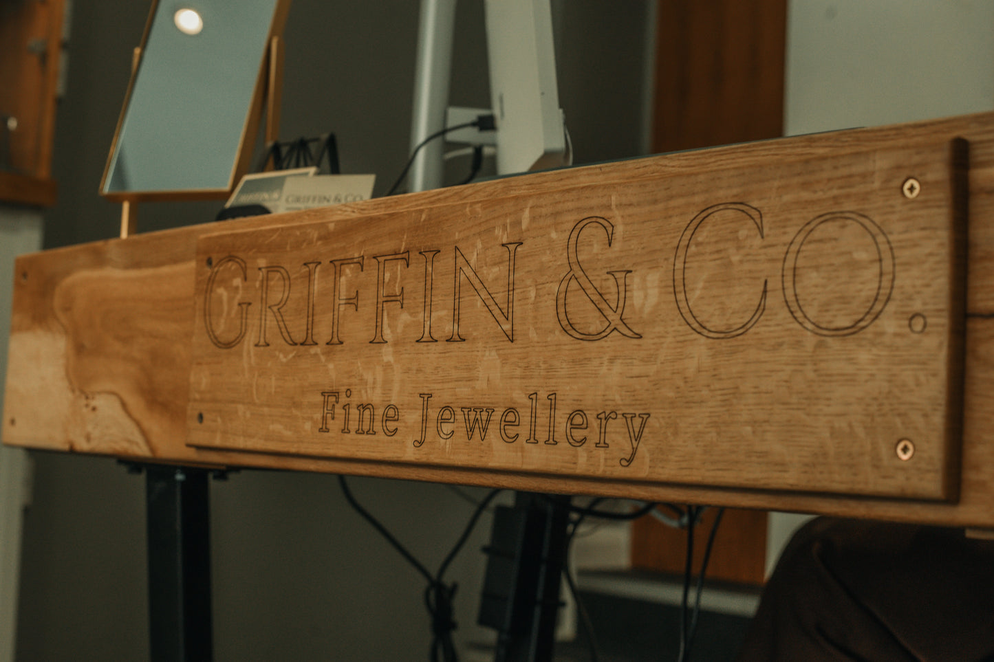 Wooden sign with 'Griffin & Co. Fine Jewellery' engraved on it.