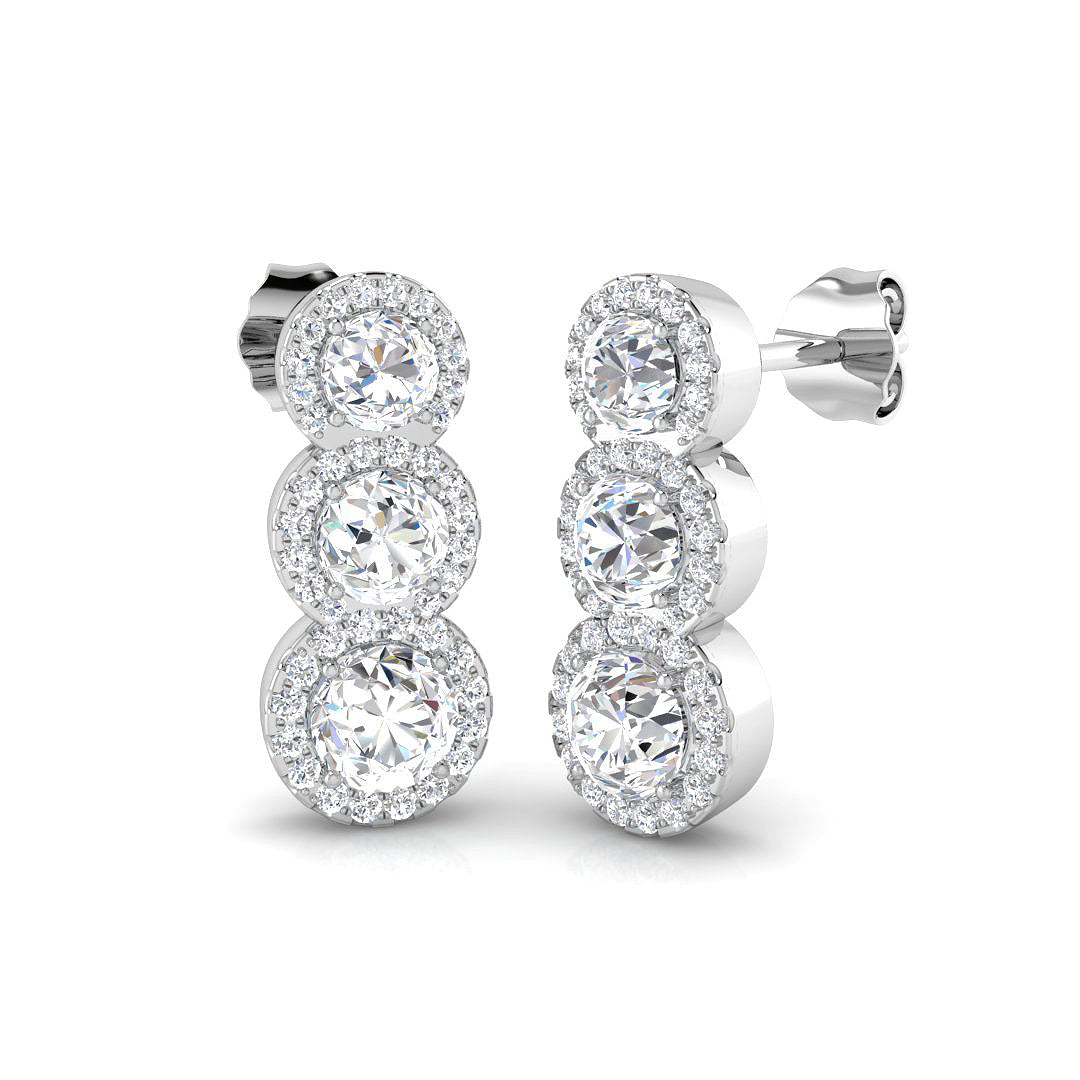 Close-up of 18ct white gold diamond stud earrings showing G/SI2 round brilliant stones