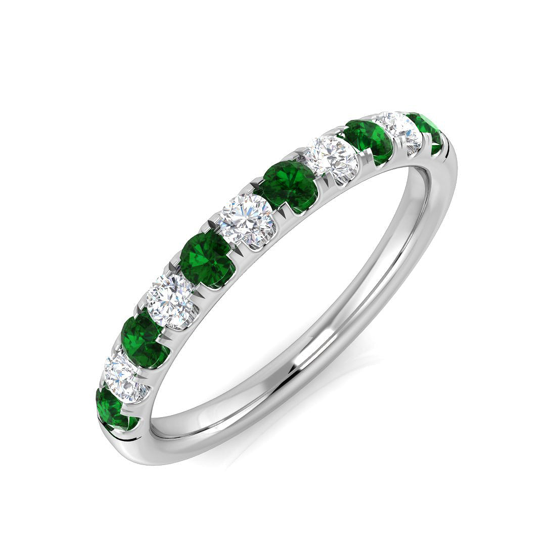 Platinum diamond and emerald ring detail view