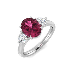 A three-stone engagement ring with an oval pink tourmaline and round diamonds, featuring a 9ct white gold band and platinum settings.