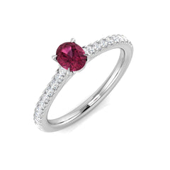 An oval pink tourmaline and diamond pavé engagement ring, crafted in 9ct white gold, on a white background.