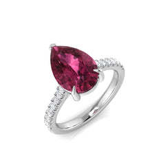 A large pear-cut pink tourmaline engagement ring with a diamond pavé band, crafted in 9ct white gold, on a white background.