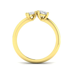 A side profile view of a two-stone diamond ring, showing the prong settings of the pear and marquise diamonds on a polished gold band.
