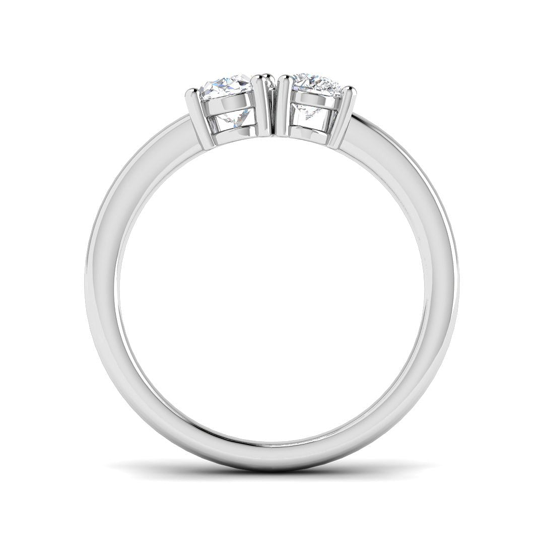 An angled view of an 18ct yellow gold Toi et Moi ring, showcasing a pear diamond and oval diamond duo.