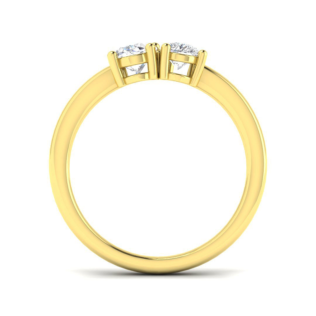 A side profile view of a yellow gold engagement ring featuring two raised settings holding lab grown diamonds.