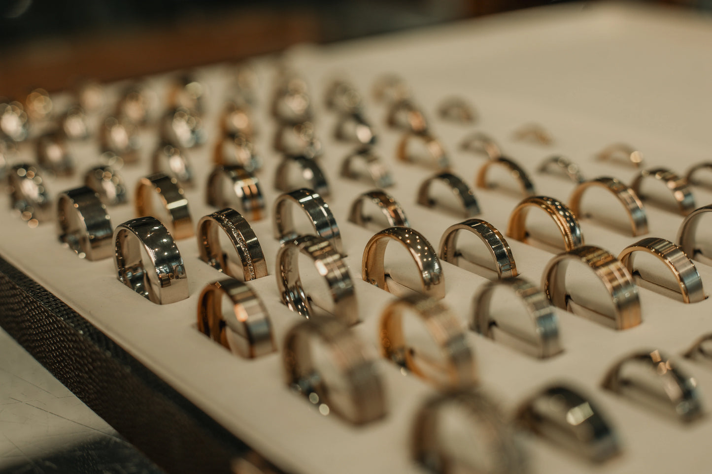 Collection of white gold and gold wedding rings on a display tray