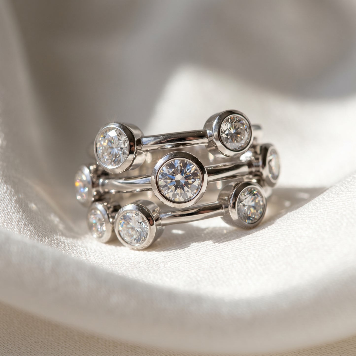 Close-up of delicate 9ct white gold ring with nine sparkling lab-grown diamonds on white fabric, showcasing craftsmanship and micro-details.