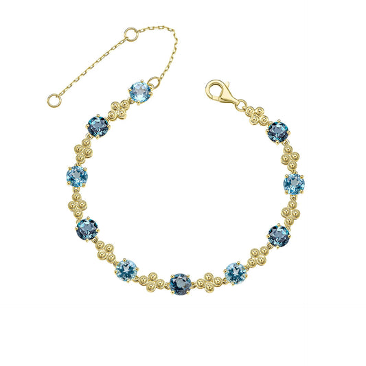 A 9ct yellow gold bracelet featuring alternating round London Blue and Swiss Blue Topaz gemstones with intricate gold detailing, shown on a white background. 1920