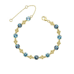 A 9ct yellow gold bracelet featuring alternating round London Blue and Swiss Blue Topaz gemstones with intricate gold detailing, shown on a white background.