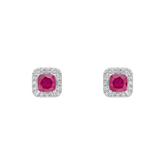 A pair of 9ct white gold stud earrings featuring a cushion-cut ruby surrounded by a diamond halo, shown on a white background.