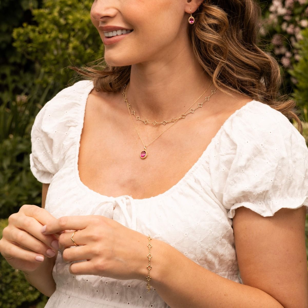 Woman wearing a white blouse with jewelry outdoors
