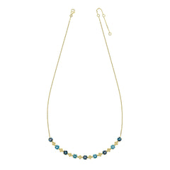 A 9ct yellow gold necklace featuring alternating stations of round London Blue and Swiss Blue Topaz gemstones with intricate gold detailing, on a white background.