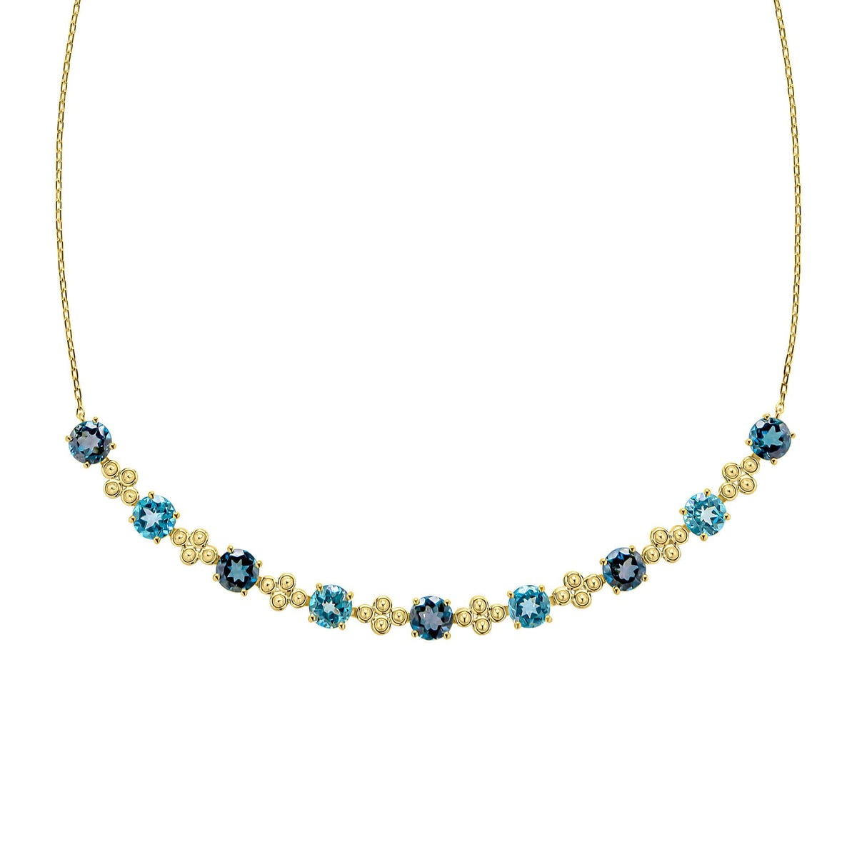 A close-up view of the blue topaz necklace, showing the detailed gold settings and the alternating shades of blue gemstones.