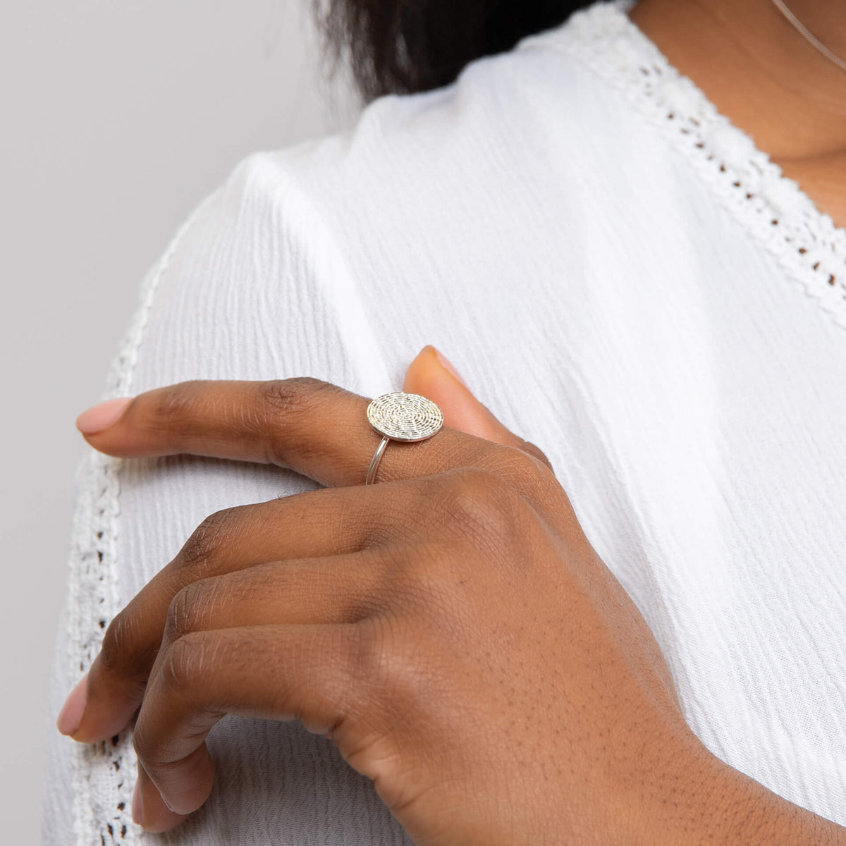 Model wearing ripple texture round disc ring
