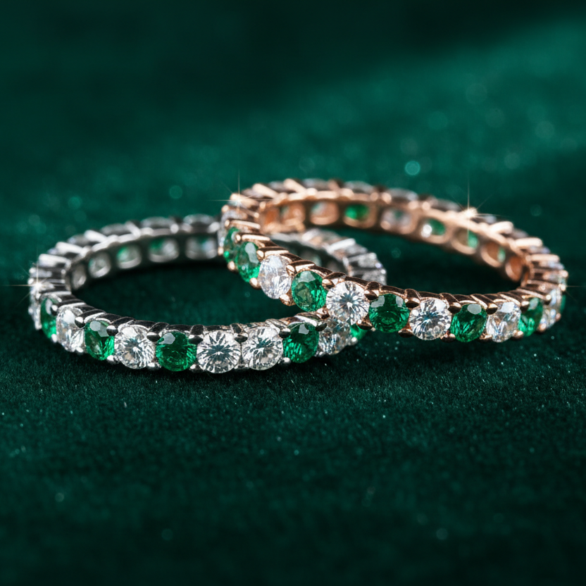 Two eternity rings on a dark green background