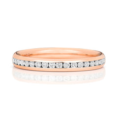 A front view of a 9ct rose gold diamond eternity ring, showcasing the warm metal tone against the white diamonds.